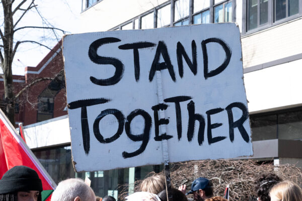 protest poster reads Stand Together