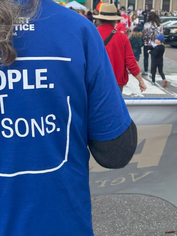 people not prisons written on shirt